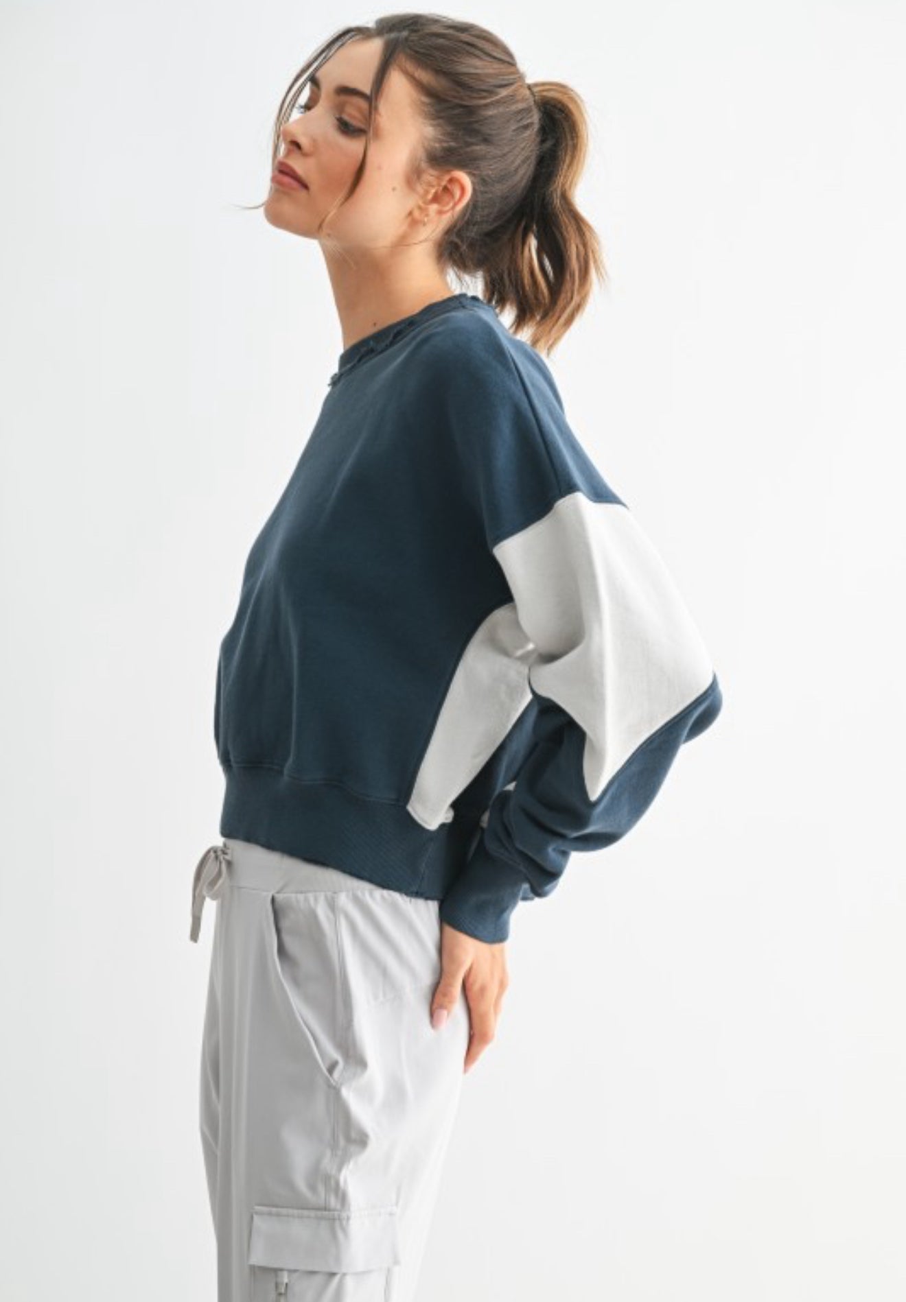 Side view of contrast sleeve oversized sweatshirt in midnight and pale gray.